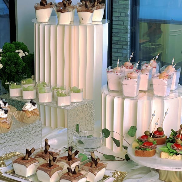 A dessert buffet with various Studio Multisweet treats, including parfaits, cupcakes, and small appetizers.