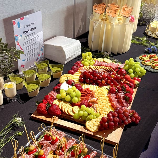 A Studio Multisweet dessert table with charcuterie, matcha tiramisu, and jasmine green grape milk pudding.
