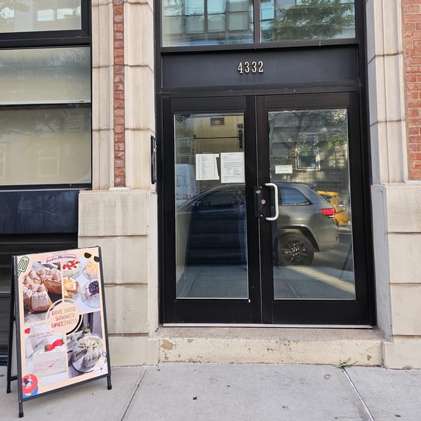 Studio Multisweet storefront with a dessert menu A-frame sign on the sidewalk.
