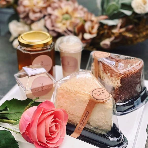 Studio Multisweet desserts: honey jar, drink, two cake slices, and a pink rose.